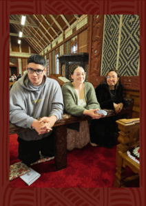 Whānau seated in the beautifully carved interior of Meri Kuia (St Mary's Church, Tikitiki)